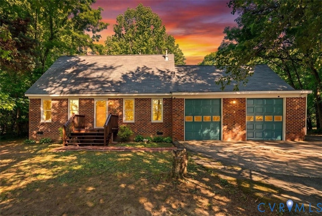 Brick exterior with a gabled roof and a wooden front porch