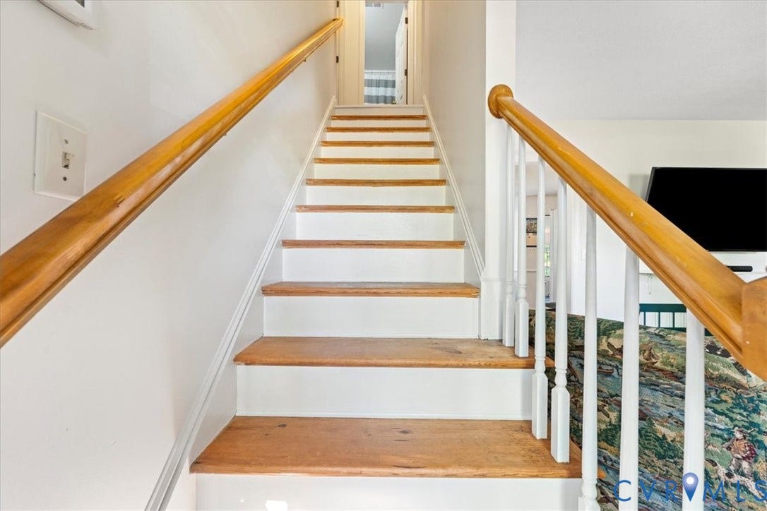 Hardwood tread staircase with white risers and wood-finish handrails