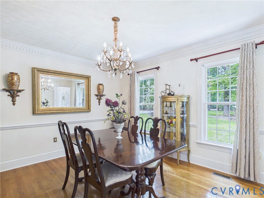 14301 Creek Stone Drive, Chesterfield, VA 23838 Dining area featuring hardwood flooring, a crystal chandelier, crown molding, and large windows with natural light