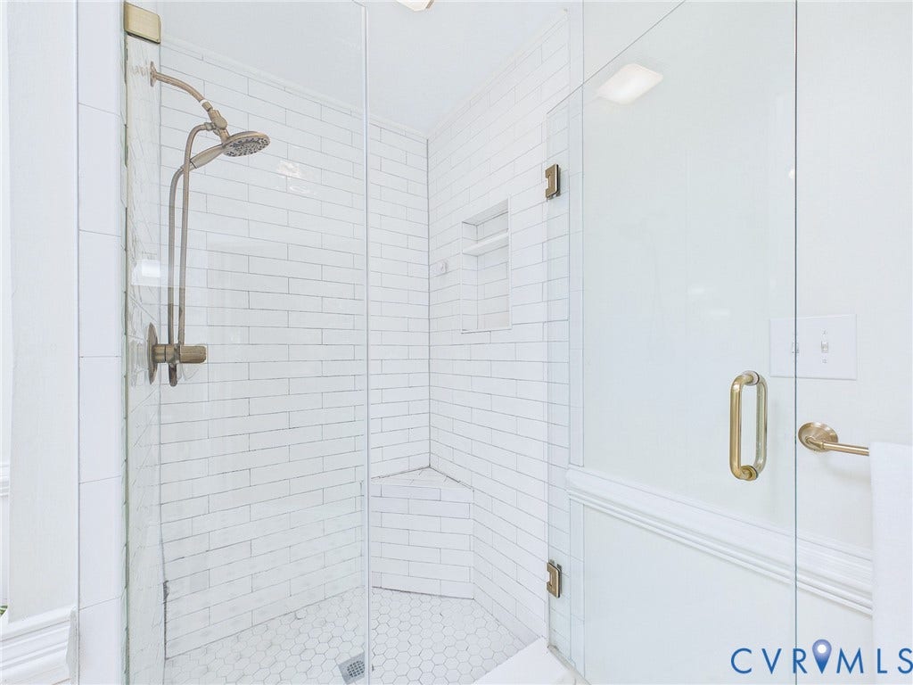 14301 Creek Stone Drive, Chesterfield, VA 23838 Glass-enclosed shower featuring white subway tile walls, a built-in shower niche, and a hexagon tile floor