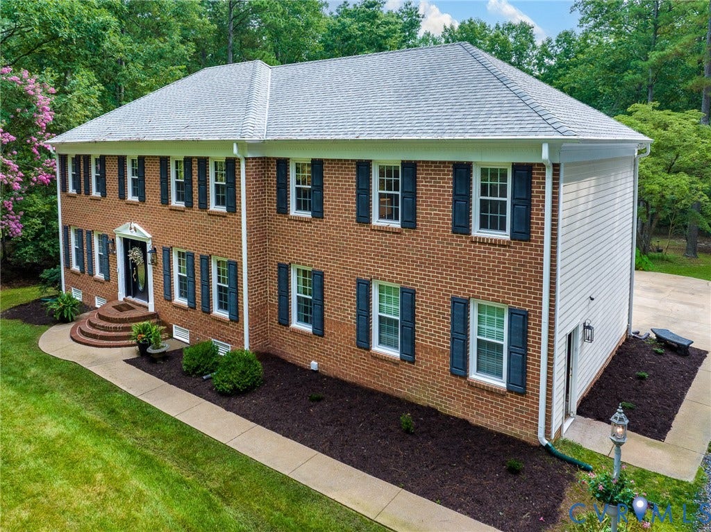 14301 Creek Stone Drive, Chesterfield, VA 23838 Traditional two-story brick residence featuring a gray shingle roof and white gutters