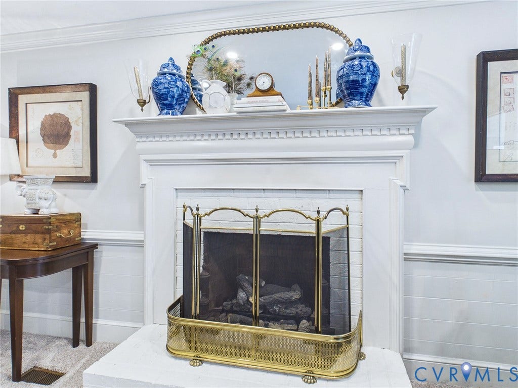 14301 Creek Stone Drive, Chesterfield, VA 23838 Fireplace featuring a white mantel, white brick hearth, and brass fire screen