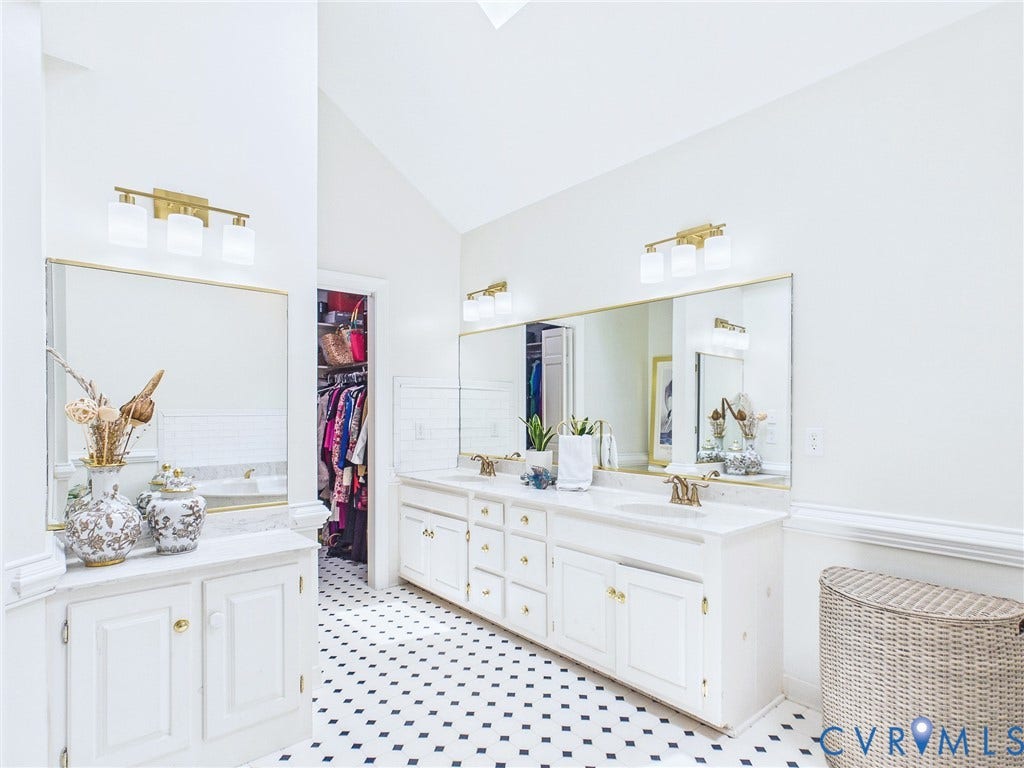 14301 Creek Stone Drive, Chesterfield, VA 23838 Vaulted ceiling bathroom featuring dual vanities with white cabinetry and gold-tone hardware