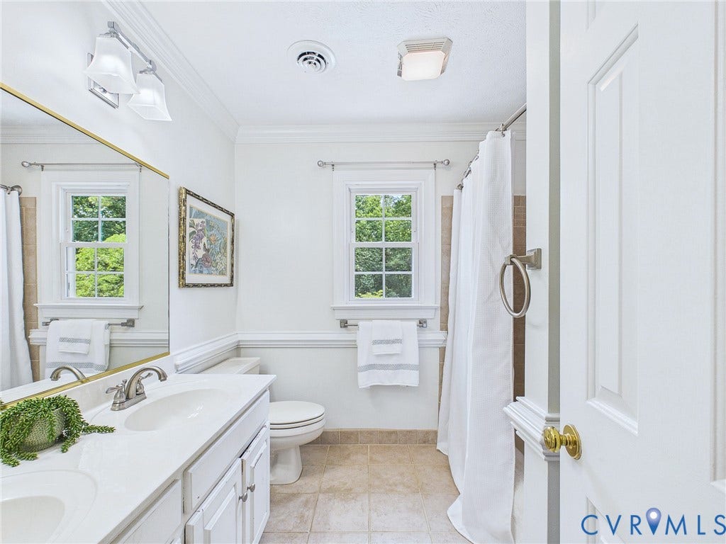 14301 Creek Stone Drive, Chesterfield, VA 23838 Bathroom featuring a dual-sink vanity with white cabinetry, a toilet, two windows, and a shower area with a curtain