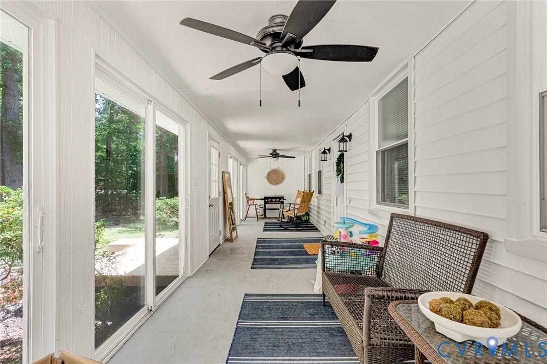 348 Forest Lane, Timberland Estates, King William, VA 23086 Screened porch featuring multiple ceiling fans, sliding glass doors, white paneled walls, and exterior-facing windows