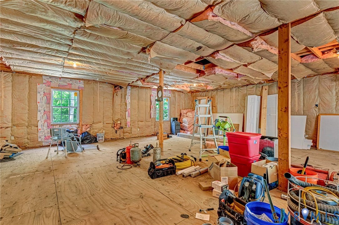 348 Forest Lane, Timberland Estates, King William, VA 23086 Unfinished interior space featuring exposed wood framing, multiple windows providing natural light, and plywood subflooring