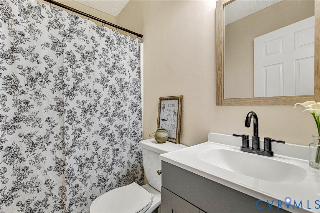 348 Forest Lane, Timberland Estates, King William, VA 23086 Bathroom vanity featuring a white countertop with integrated sink, matte black faucet, and gray cabinetry