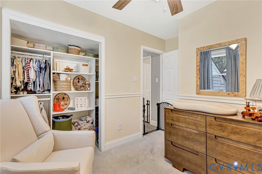 348 Forest Lane, Timberland Estates, King William, VA 23086 Built-in closet shelving and hanging storage, wood-finish ceiling fan, wood-finish dresser, wall-mounted mirror, and neutral carpet flooring