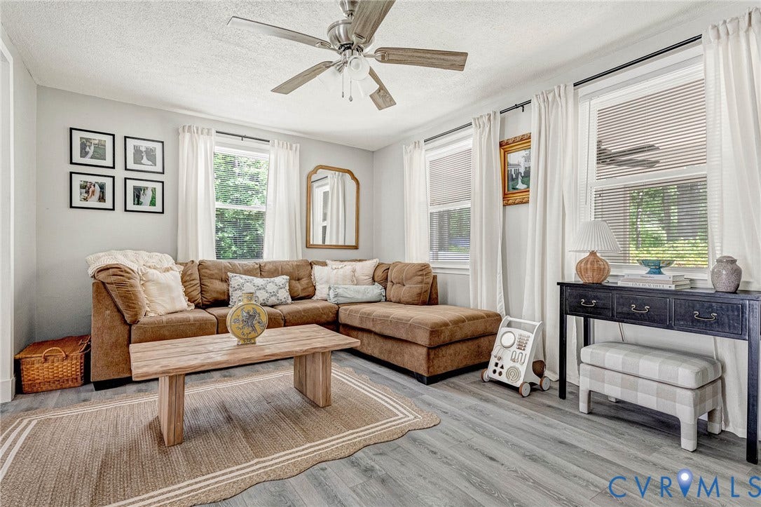 348 Forest Lane, Timberland Estates, King William, VA 23086 Living area featuring wood-finish flooring, multiple windows, a ceiling fan, and light-toned wall paint