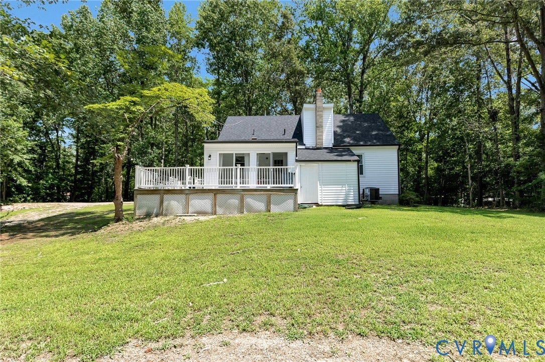 348 Forest Lane, Timberland Estates, King William, VA 23086 Rear exterior featuring white siding, a dark roof, and a prominent white deck with railings