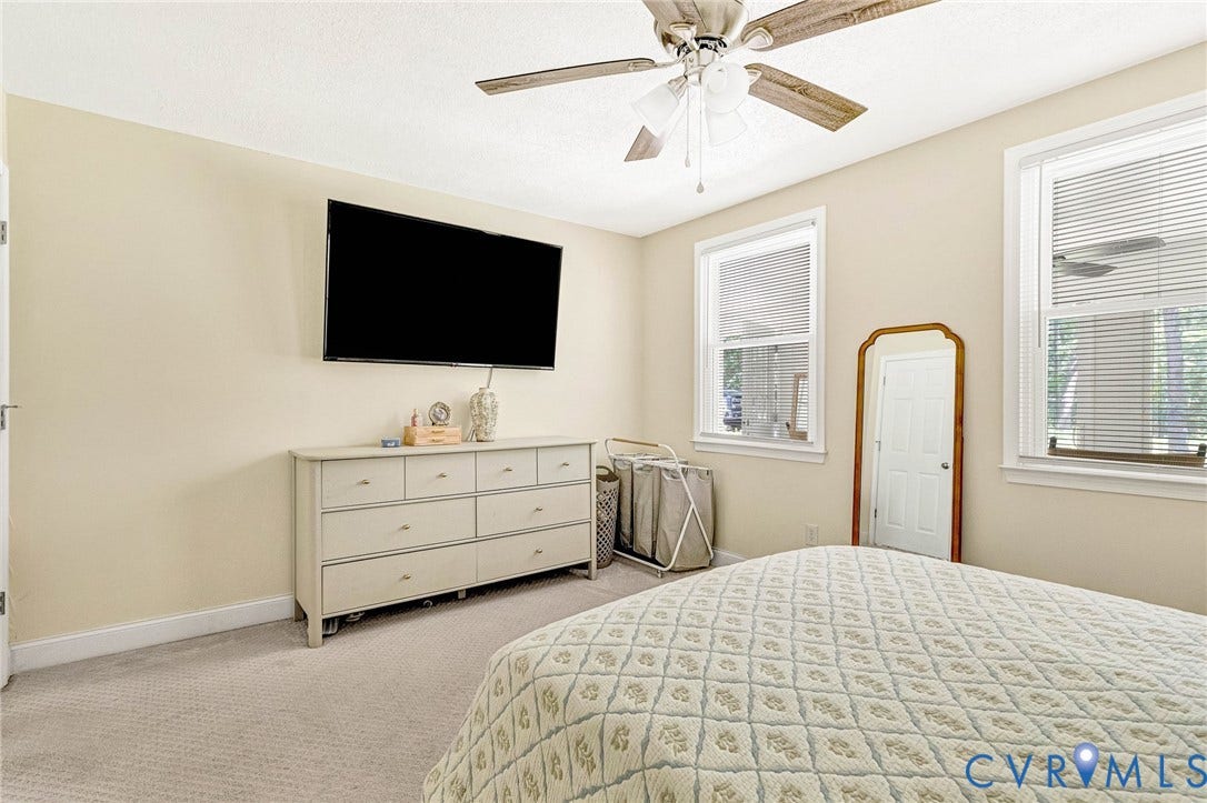 348 Forest Lane, Timberland Estates, King William, VA 23086 Carpeted interior space featuring a ceiling fan with integrated lighting, two windows with blinds, and light-toned walls