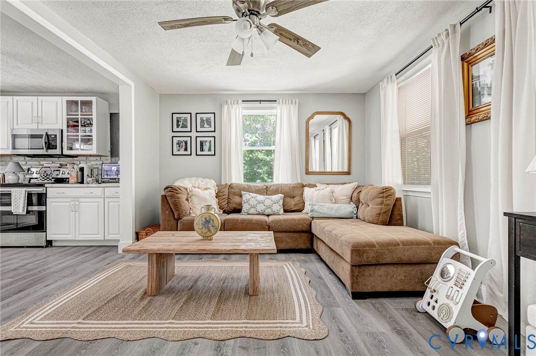 348 Forest Lane, Timberland Estates, King William, VA 23086 Living area featuring wood-finish flooring, a ceiling fan with light fixture, and multiple windows