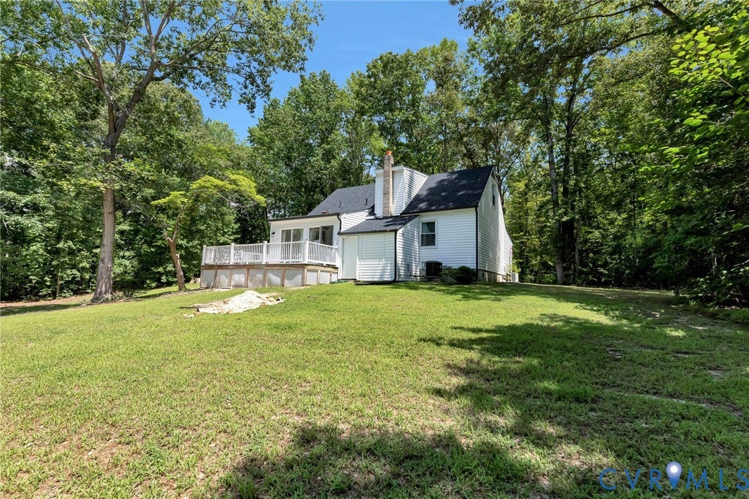 348 Forest Lane, Timberland Estates, King William, VA 23086 Expansive lawn surrounding a white-sided residence with a black shingled roof
