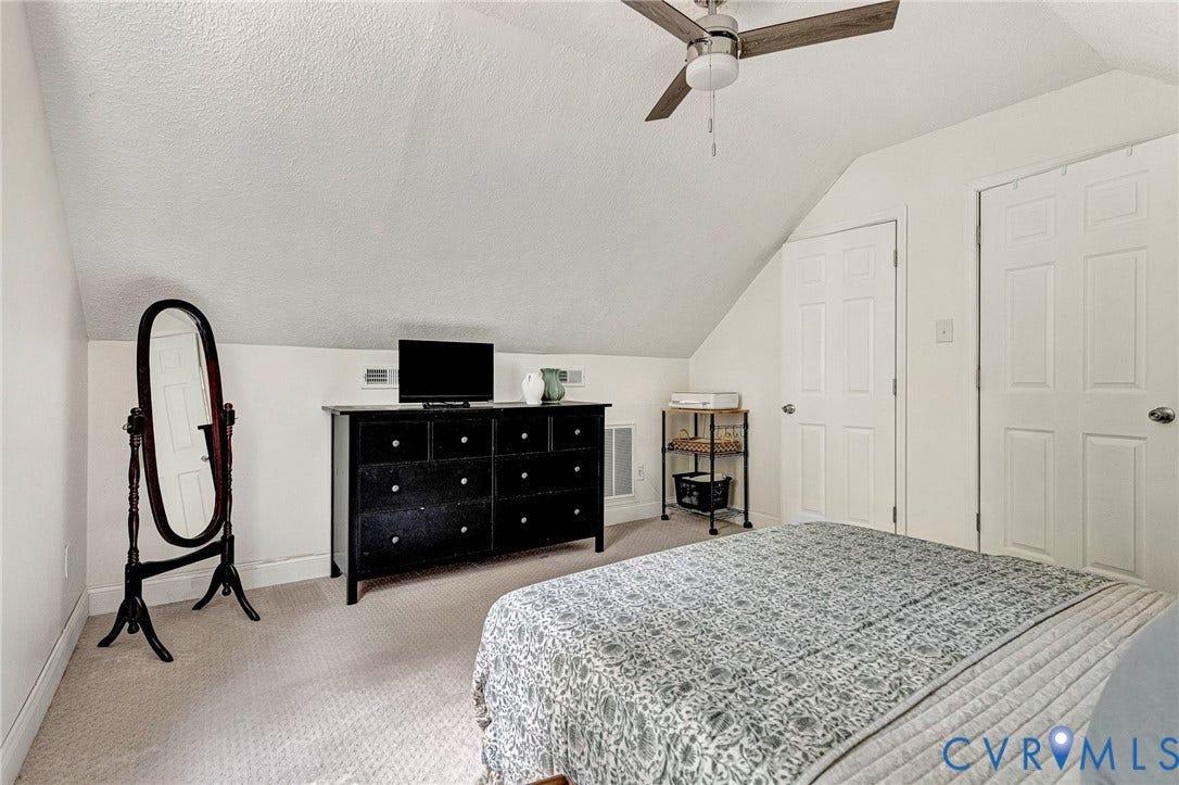 348 Forest Lane, Timberland Estates, King William, VA 23086 Carpeted room featuring a sloped ceiling, overhead ceiling fan with light, and two white paneled doors