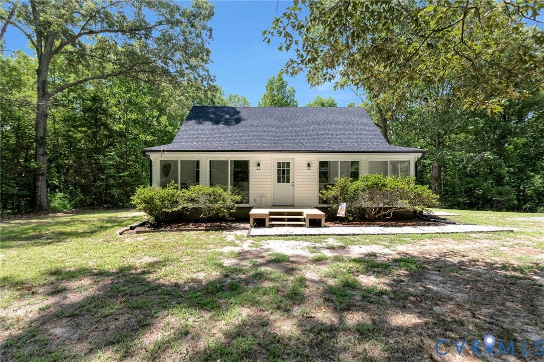 348 Forest Lane, Timberland Estates, King William, VA 23086 White siding exterior with a dark shingled roof, featuring a covered porch with large windows, and a front entry door with transom lites