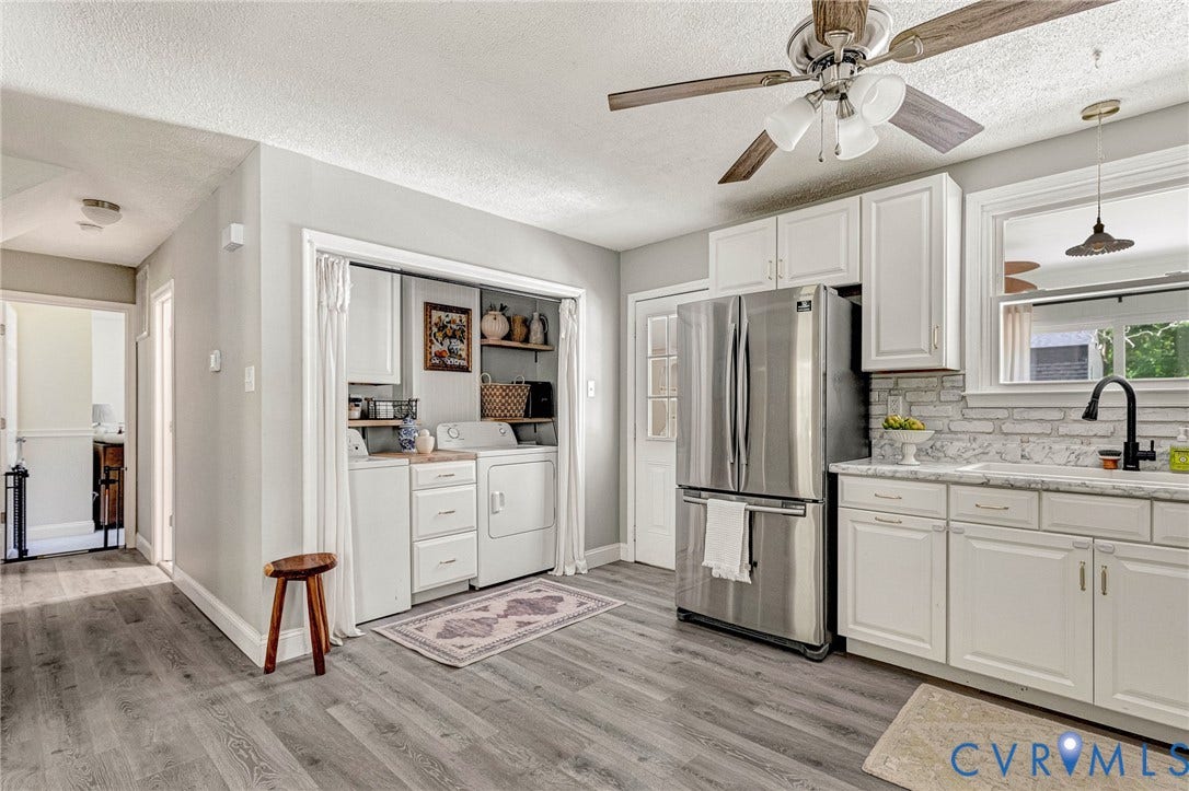 348 Forest Lane, Timberland Estates, King William, VA 23086 Bright kitchen featuring white cabinetry, stainless steel refrigerator, white tile backsplash, and light-toned countertops