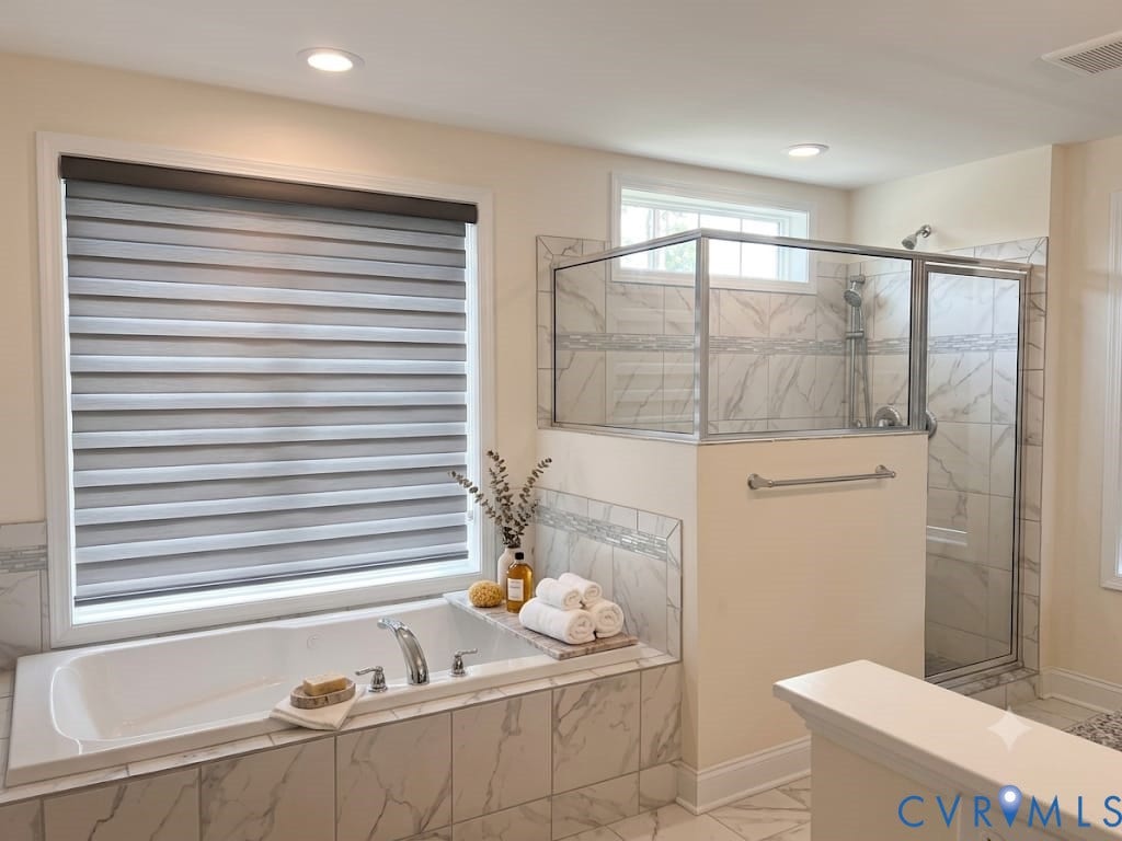 18037 Bay Point Way, Moseley, VA 23120 Spacious bathroom featuring a built-in soaking tub with deck-mounted fixtures, a glass-enclosed shower with tile surround, and recessed lighting
