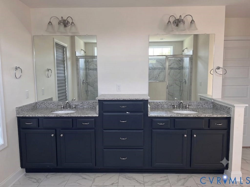 18037 Bay Point Way, Moseley, VA 23120 Dual vanity featuring dark cabinetry, granite countertops, and undermount sinks