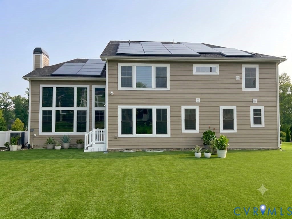18037 Bay Point Way, Moseley, VA 23120 Expansive rear exterior featuring a tan siding facade and multiple solar panel arrays