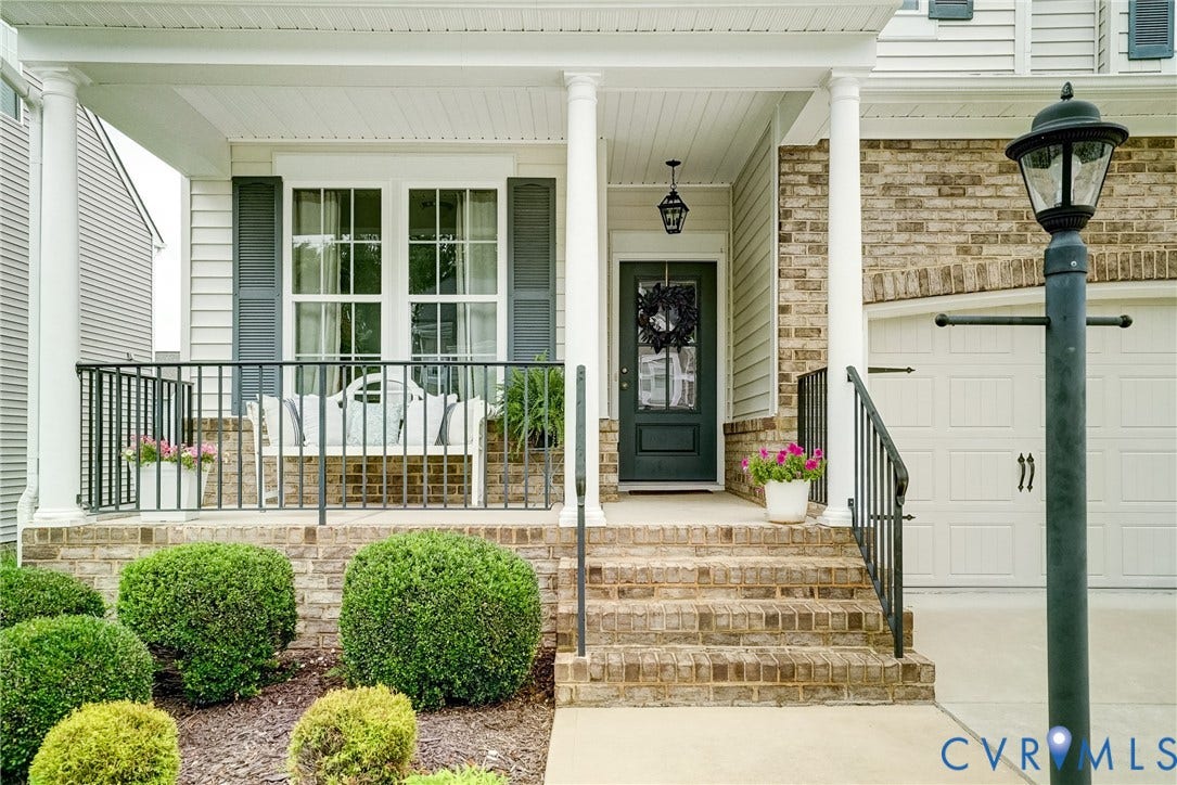 18024 Twin Falls Lane, Aston Oaks, Moseley, VA 23120 Brick facade with white siding accents and a covered front porch featuring white columns