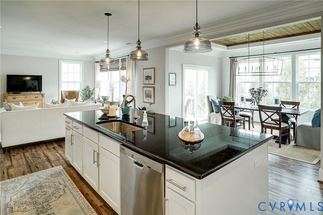 18024 Twin Falls Lane, Aston Oaks, Moseley, VA 23120 Spacious open-concept kitchen and dining area featuring a large center island with dark countertop, stainless steel appliances, white cabinetry, and wood-finish flooring