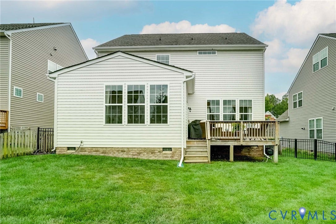 18024 Twin Falls Lane, Aston Oaks, Moseley, VA 23120 Manicured lawn with a rear wooden deck and an attached sunroom addition
