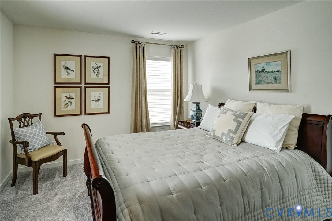 18024 Twin Falls Lane, Aston Oaks, Moseley, VA 23120 Carpeted room featuring a window with blinds and drapery, white walls, and a built-in ventilation register