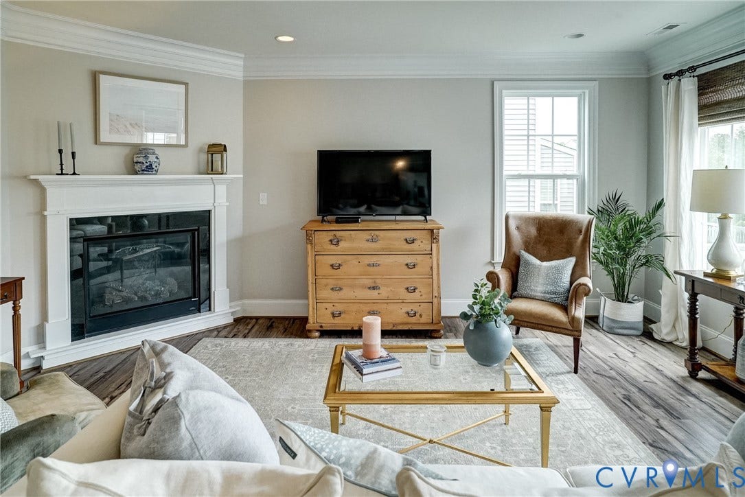 18024 Twin Falls Lane, Aston Oaks, Moseley, VA 23120 Living area featuring a white mantel fireplace, crown molding, recessed lighting, wood-finish flooring, and a double-hung window