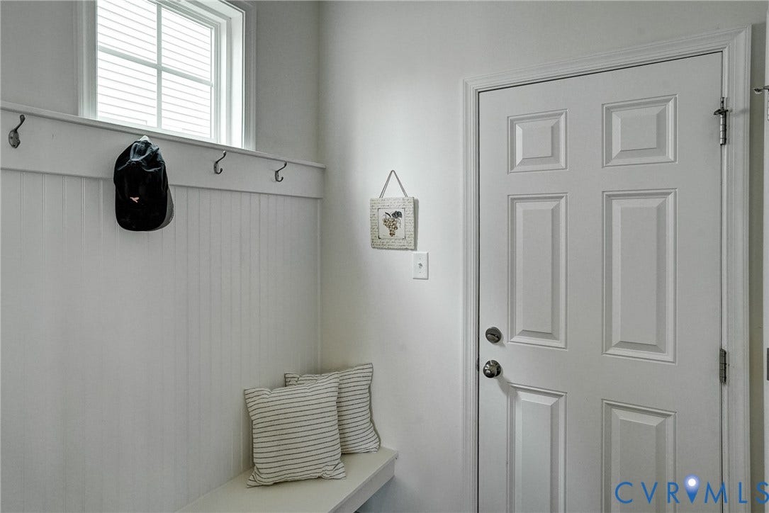 18024 Twin Falls Lane, Aston Oaks, Moseley, VA 23120 Entryway mudroom featuring white beadboard paneling, a built-in bench, and coat hooks