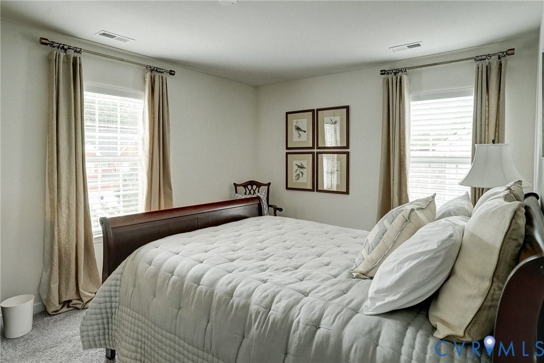 18024 Twin Falls Lane, Aston Oaks, Moseley, VA 23120 Bright bedroom featuring two windows with horizontal blinds and drapery rods