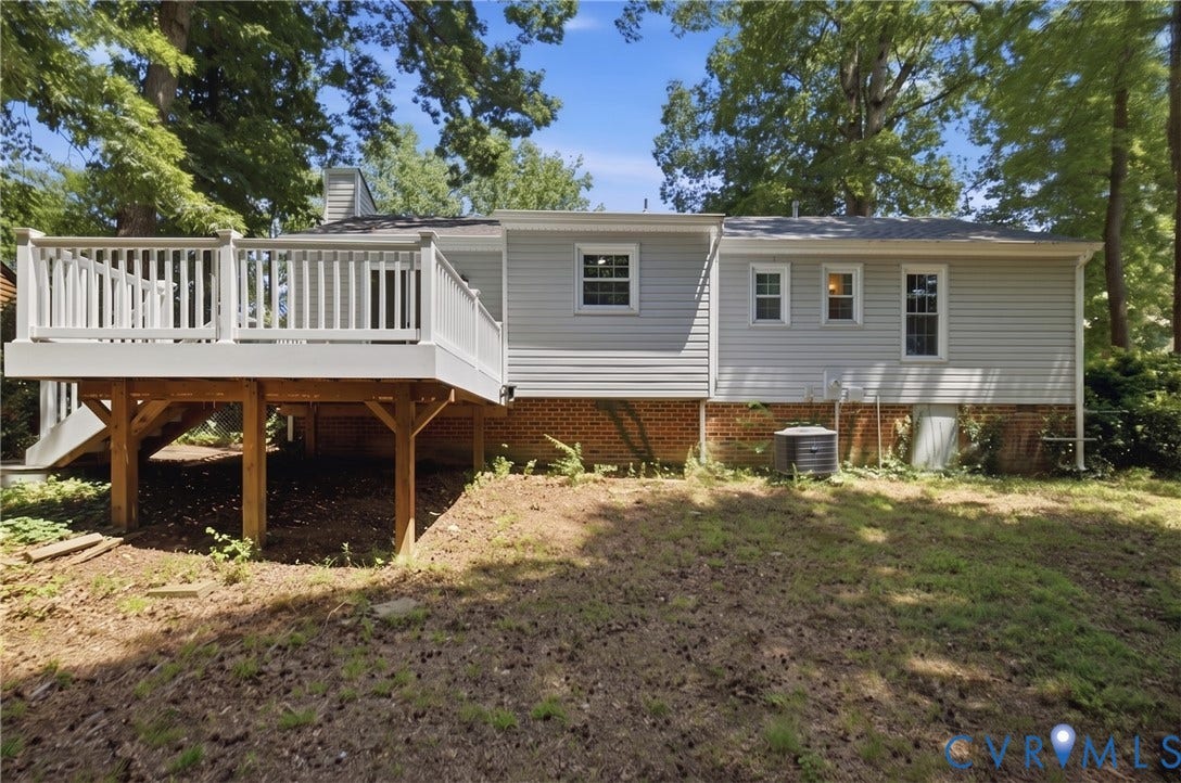 3224 Wyntrebrooke Drive, North Chesterfield, VA 23235 Rear exterior featuring a spacious white deck with balusters, a sturdy wood support structure, and a brick foundation