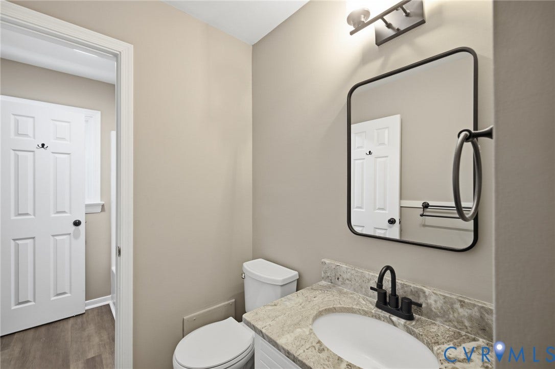 3224 Wyntrebrooke Drive, North Chesterfield, VA 23235 Bathroom featuring a vanity with an undermount sink, stone countertop, and matte black faucet