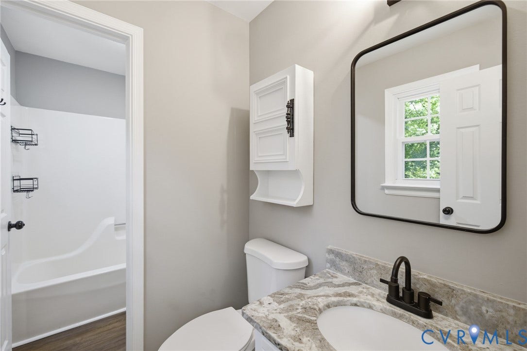 3224 Wyntrebrooke Drive, North Chesterfield, VA 23235 Bathroom vanity featuring a light-toned stone countertop, integrated sink, and matte black faucet