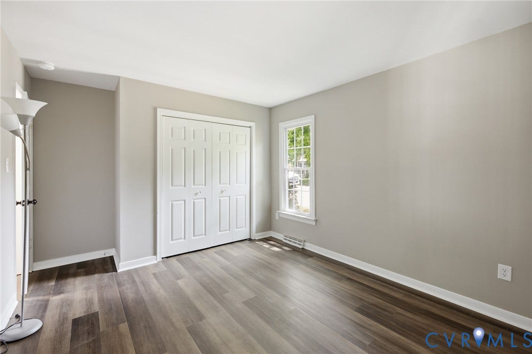 3224 Wyntrebrooke Drive, North Chesterfield, VA 23235 Neutral-toned interior featuring wood-finish flooring, white baseboards, and a white bi-fold closet door