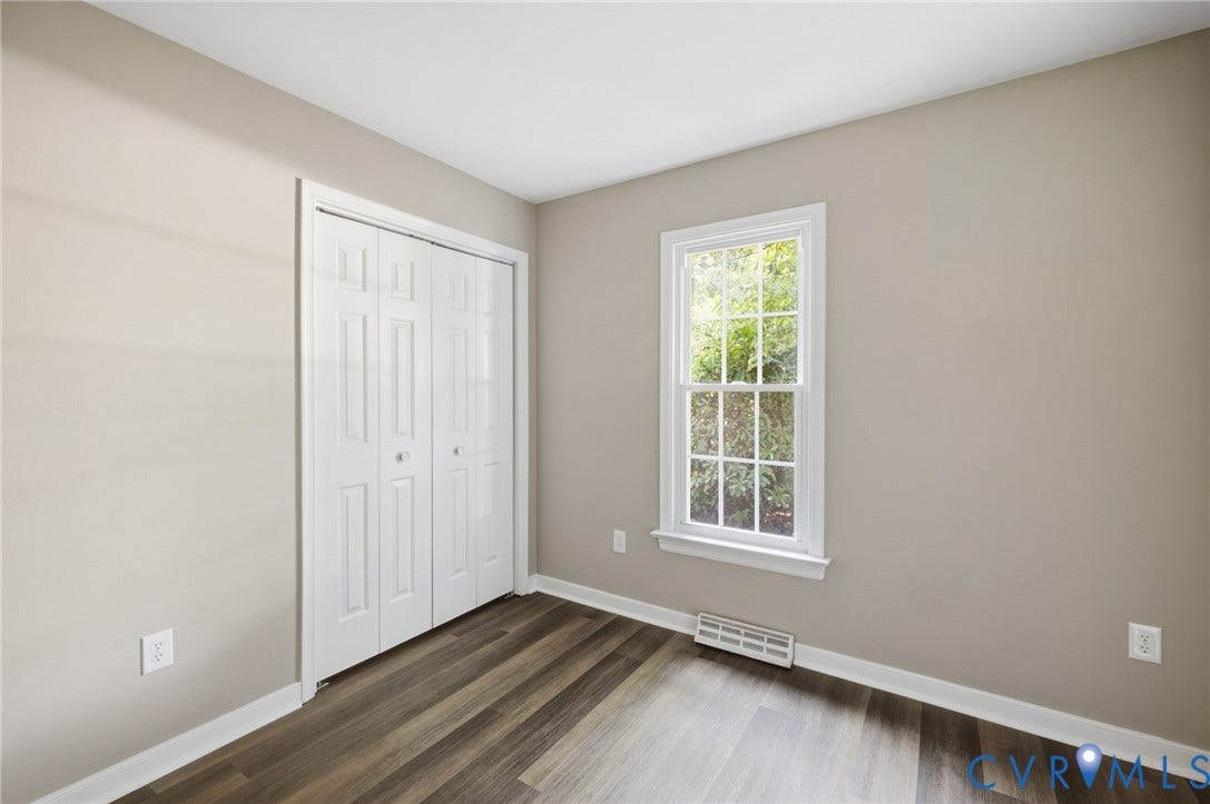 3224 Wyntrebrooke Drive, North Chesterfield, VA 23235 Room featuring wood-finish flooring, neutral wall tones, a white trim window, and bifold closet doors