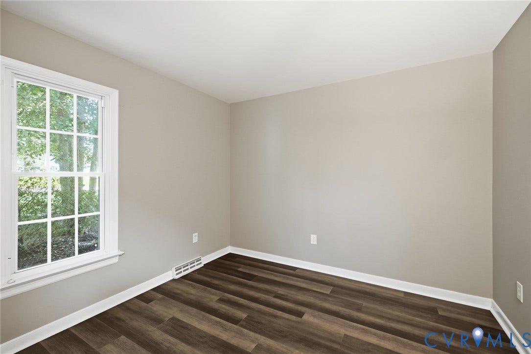 3224 Wyntrebrooke Drive, North Chesterfield, VA 23235 Neutral painted walls with crisp white trim, wood-finish flooring, and a multi-pane window
