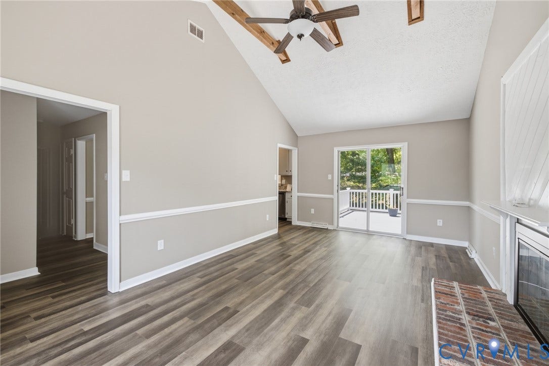 3224 Wyntrebrooke Drive, North Chesterfield, VA 23235 Spacious living area featuring a vaulted ceiling with exposed wood beams and a ceiling fan
