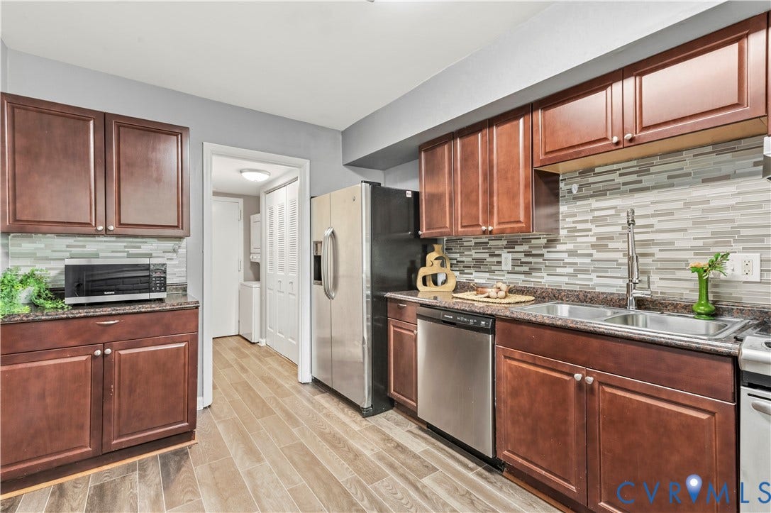 908 Winterstick Place, Highland Springs, VA 23223 Modern kitchen featuring wood-finish flooring and rich brown cabinetry