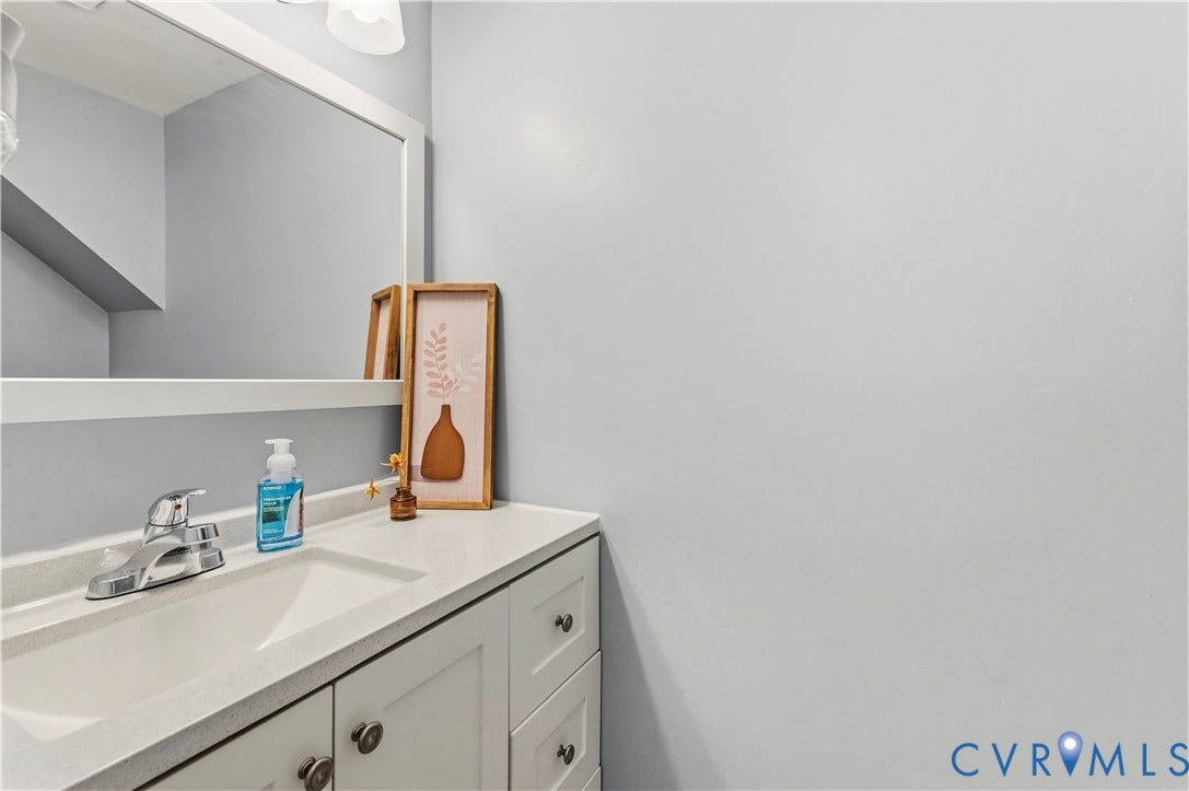 908 Winterstick Place, Highland Springs, VA 23223 Vanity with an integrated sink, polished chrome faucet, white countertop, and white cabinetry featuring knob hardware