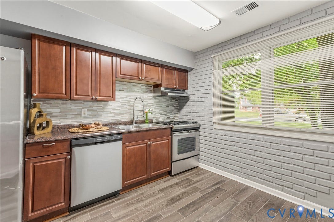 908 Winterstick Place, Highland Springs, VA 23223 Kitchen featuring wood-finish cabinetry, granite-style countertops, a mosaic tile backsplash, and stainless steel appliances