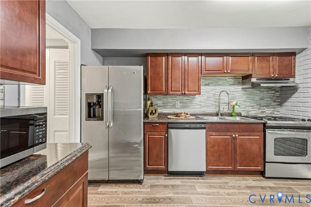 908 Winterstick Place, Highland Springs, VA 23223 Kitchen featuring wood-finish flooring, dark wood cabinetry, and stainless steel appliances