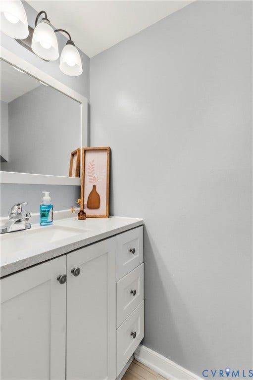 908 Winterstick Place, Highland Springs, VA 23223 Bathroom vanity featuring a light-colored countertop, integrated sink, and white shaker-style cabinetry with dark hardware
