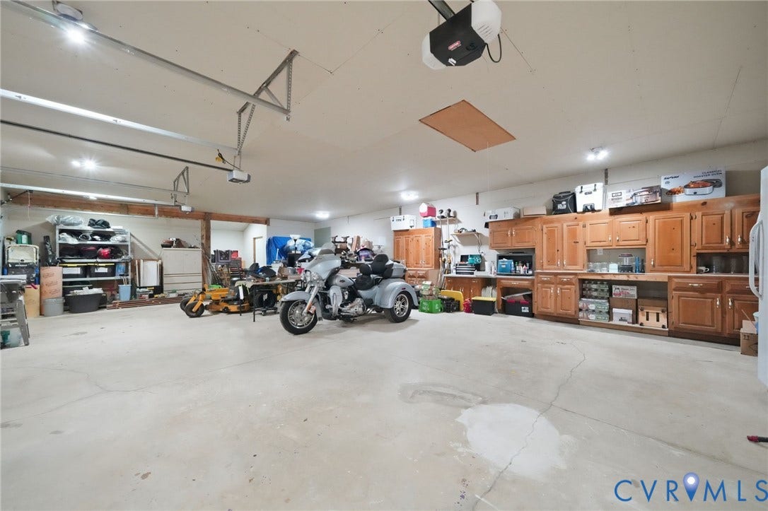 2231 Red Lane Road, Powhatan, VA 23139 More than just a garage, this expansive 3-car space is a dream come true for hobbyists, craftsmen, car enthusiasts, & anyone who needs room to create. Complete w/a workshop, abundant LED lighting, wood cabinetry, & plenty of space for vehicles/equipment, the possibilities are endless.