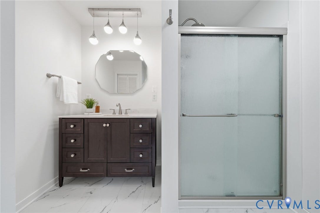 2231 Red Lane Road, Powhatan, VA 23139 Retreat to this sophisticated spa-inspired bath, complete w/a richly appointed vanity, glass-enclosed shower, marble-look tile, & designer lighting.