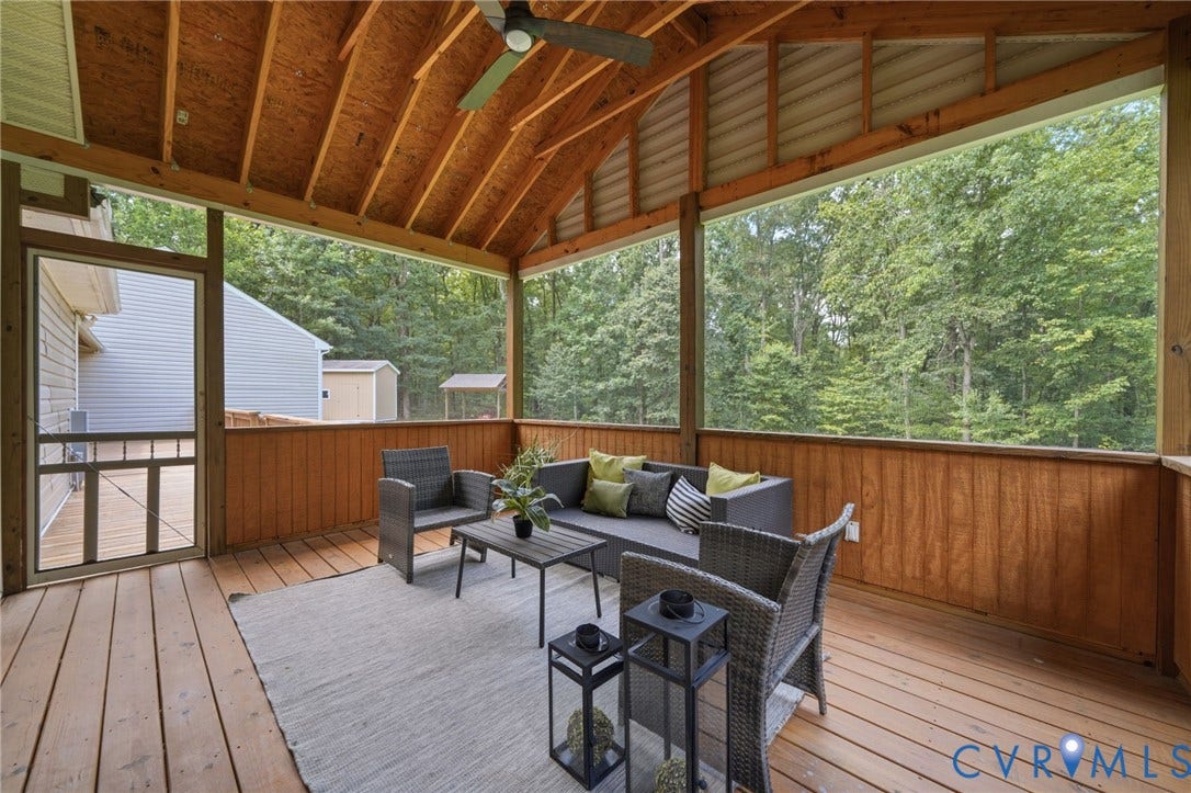 2231 Red Lane Road, Powhatan, VA 23139 Surrounded by the beauty of nature, this screened porch offers a tranquil getaway w/its ceiling fan, warm wood-paneled walls, & sweeping views of mature trees, creating the perfect setting to relax & unwind.