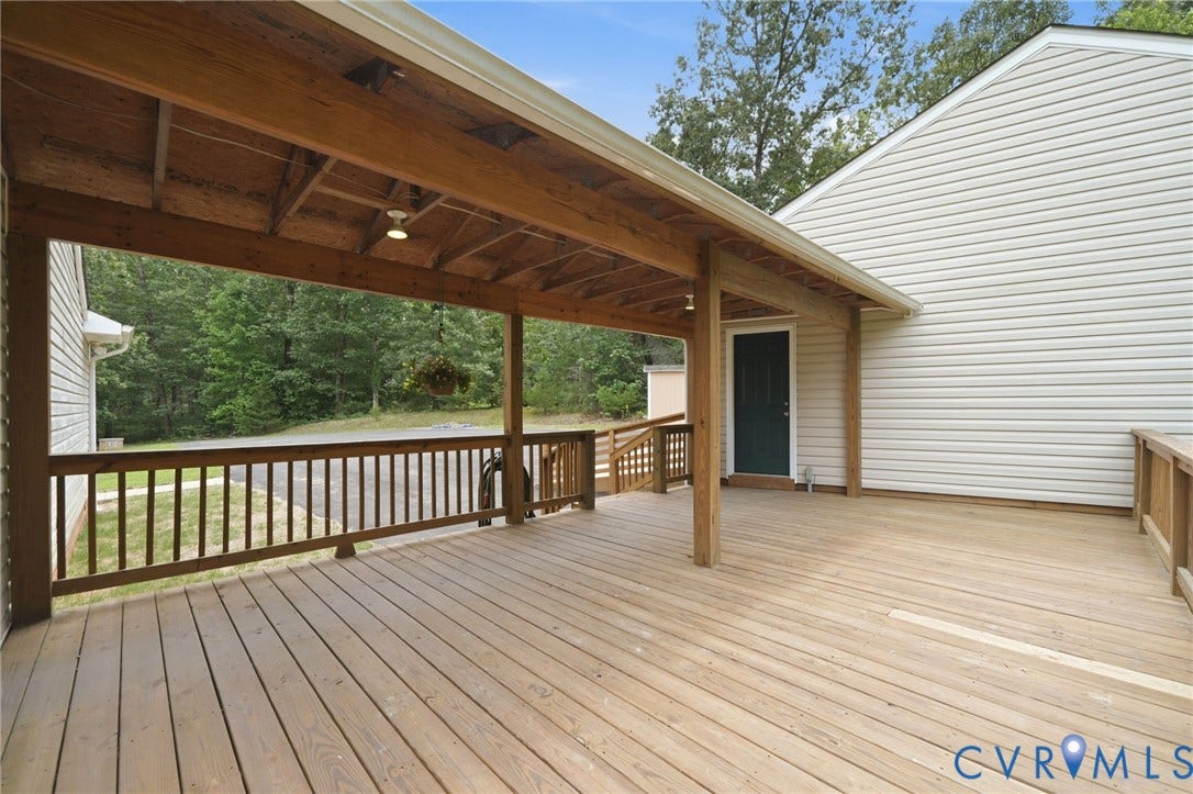 2231 Red Lane Road, Powhatan, VA 23139 Unwind on the expansive deck overlooking the backyard & peaceful wooded views, the perfect spot to sip your morning coffee, watch the kids play, or simply enjoy the sights & sounds of nature.