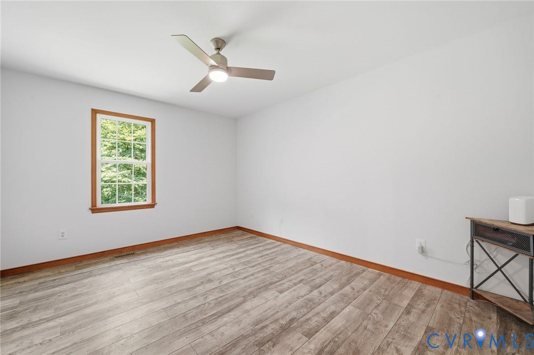 2231 Red Lane Road, Powhatan, VA 23139 Bedroom #3 - Bedroom #3 offers a serene setting w/peaceful outdoor views, a ceiling fan w/integrated lighting, & an abundance of natural light. Two closets.