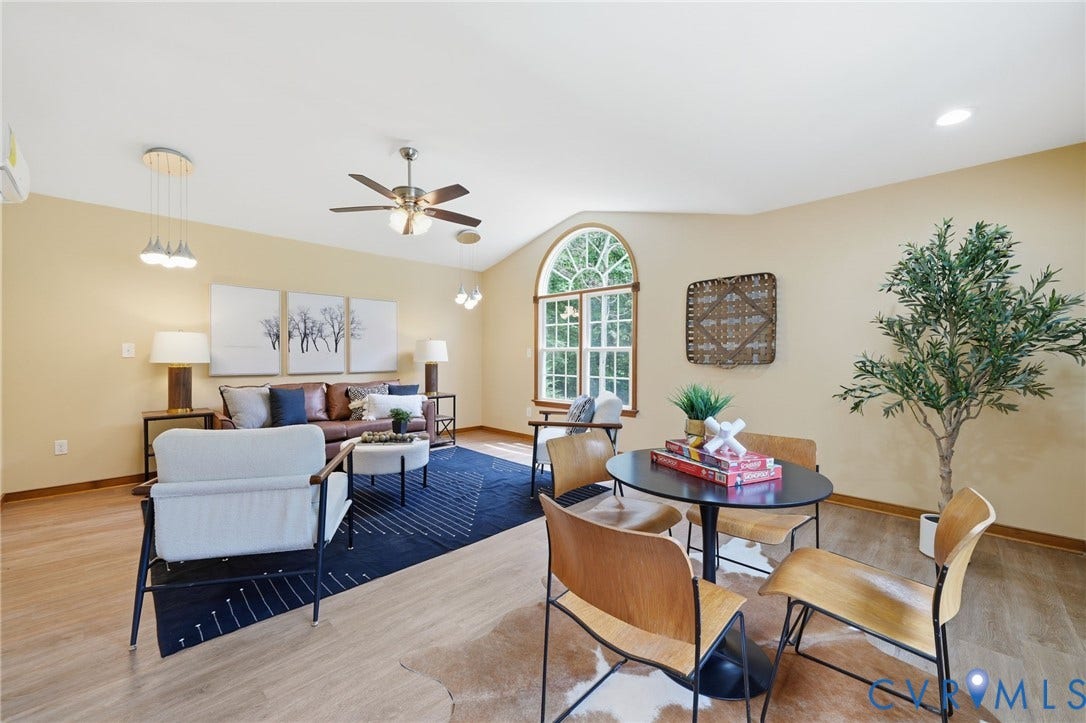 2231 Red Lane Road, Powhatan, VA 23139 Spacious living room featuring vaulted ceilings, ceiling fan with integrated lighting, and abundant natural light from an arched window