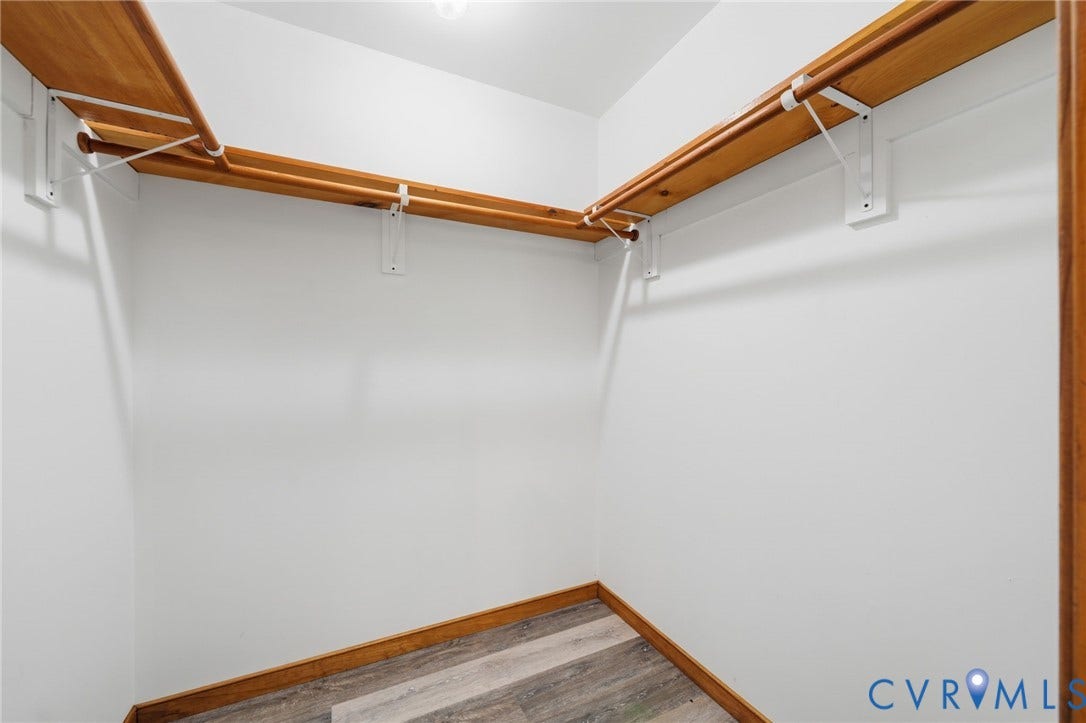 2231 Red Lane Road, Powhatan, VA 23139 Expansive walk-in closet designed w/abundant storage options for flexibility, including wood shelving, hanging rods, & integrated lighting.