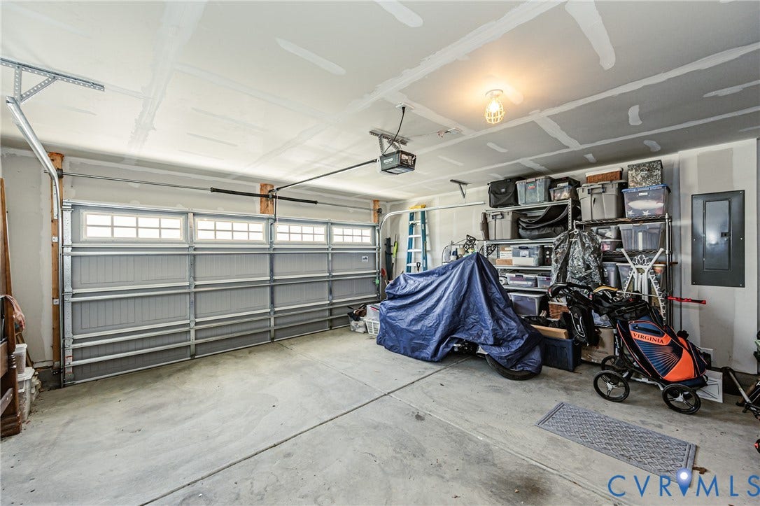7627 E Danube Loop, New Kent, VA 23124 Concrete floor garage with a double-width garage door and upper window panels